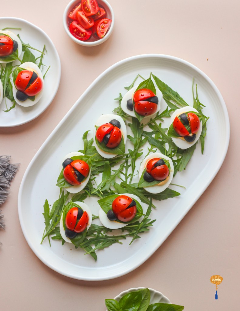 Deviled eggs with cherry tomato ladybugs