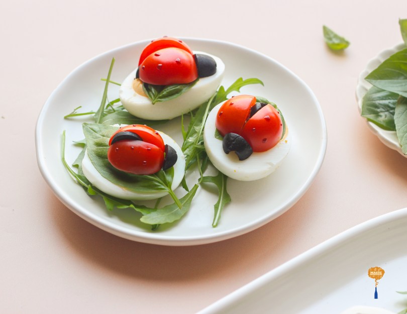 Deviled eggs with cherry tomato ladybugs